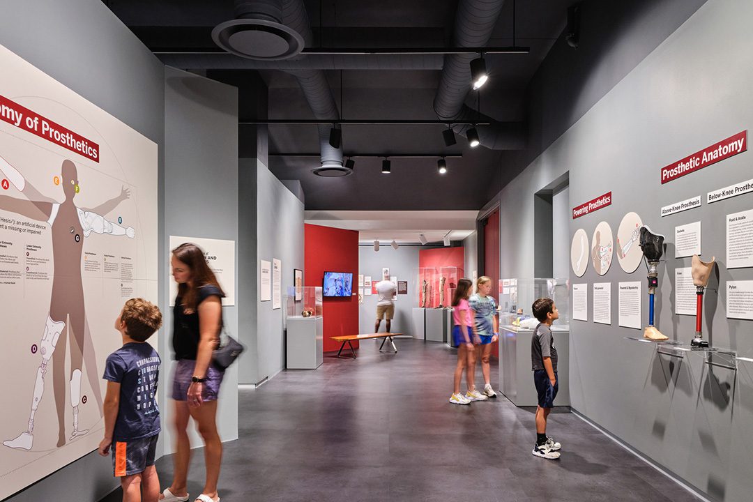 Interior photo of families looking at the exhibits in the Wylie Gallery.